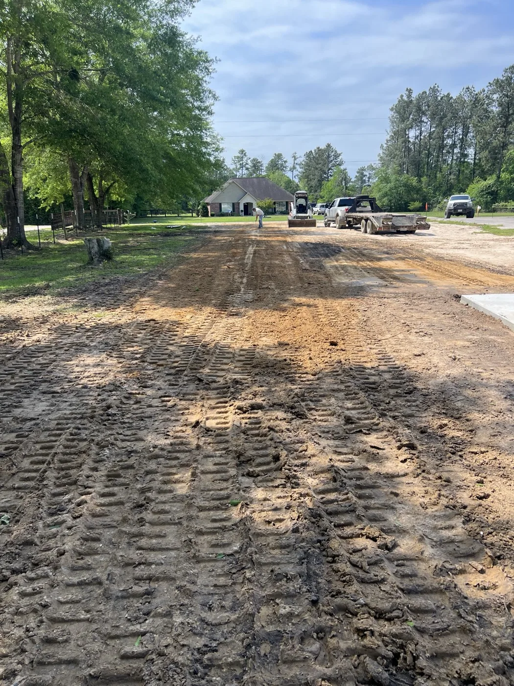 Dirt driveway being built with the machines down the lane