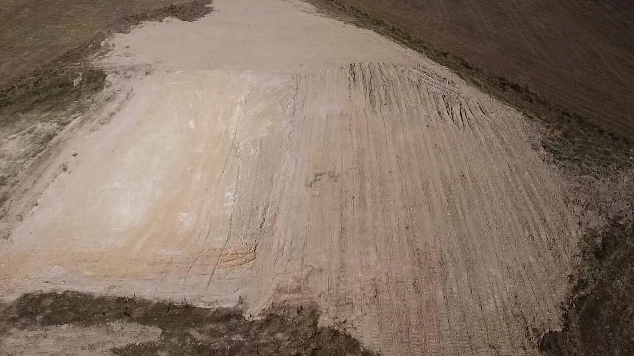 Aerial view of a large sandy pad graded smooth